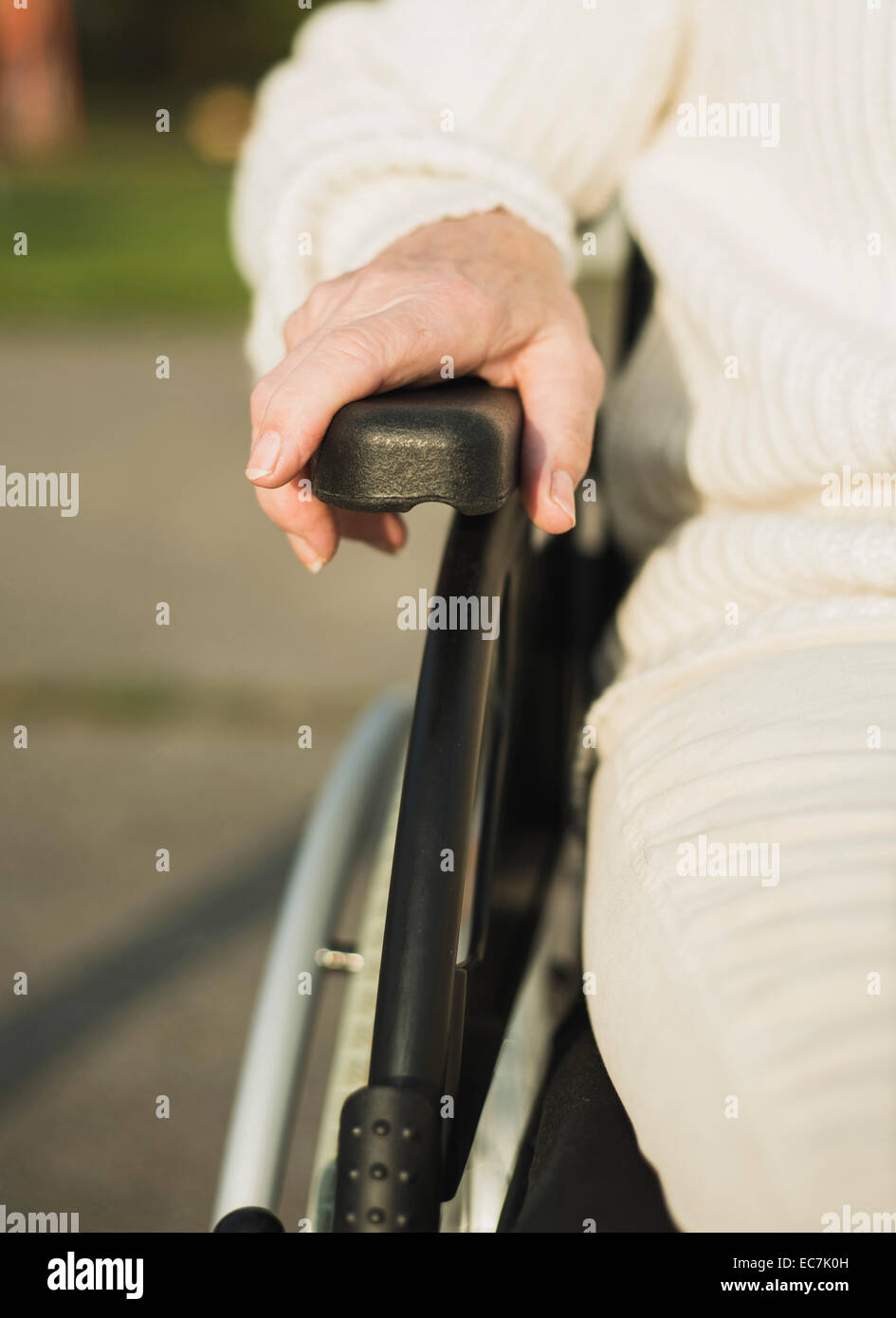 Hand of senior woman on armrest of  wheelchair Stock Photo