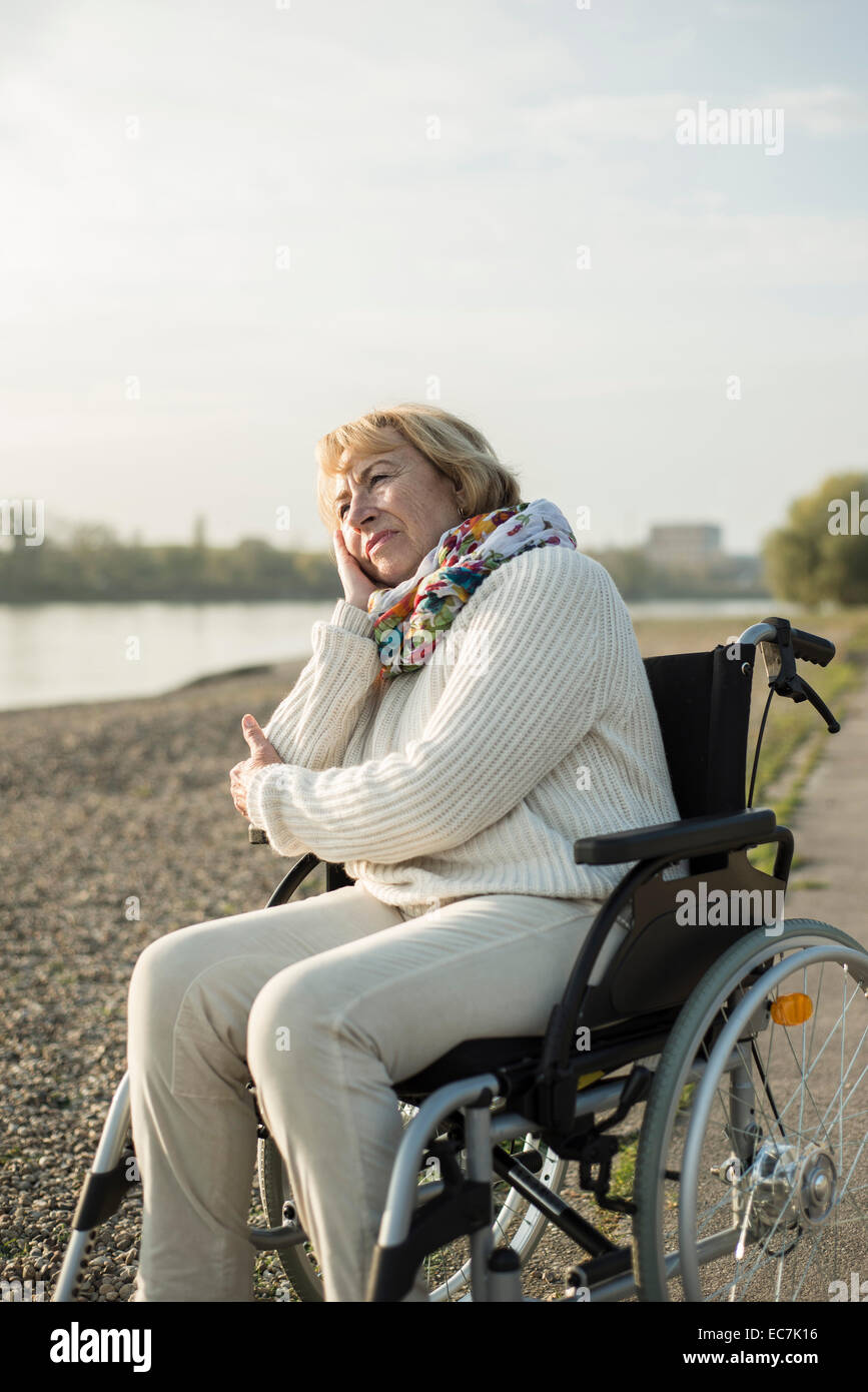 Senior woman sitting in wheelchair Stock Photo
