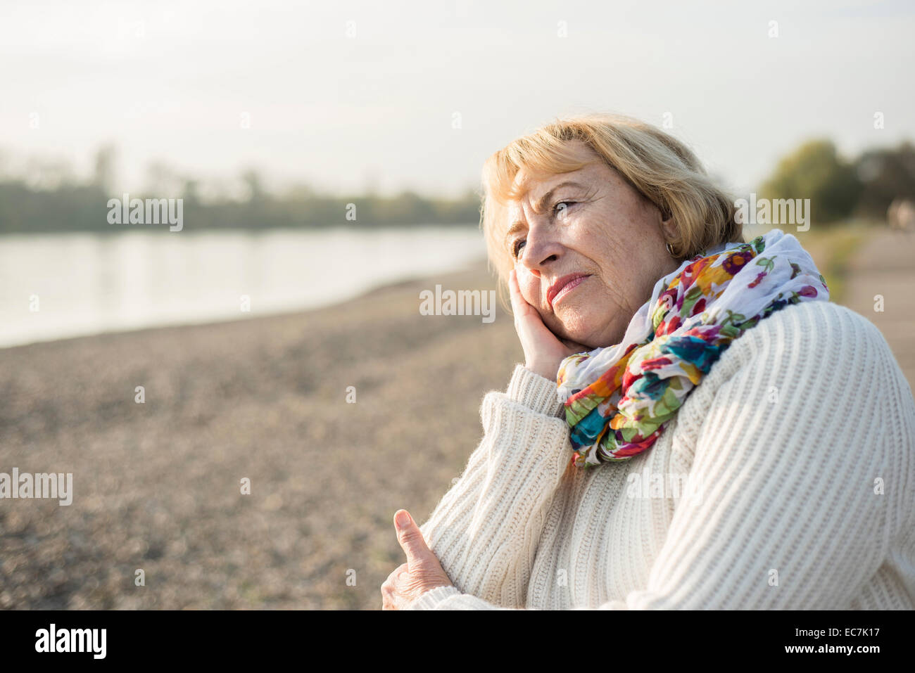 Portrait of pensive senior woman with colourful scarf Stock Photo