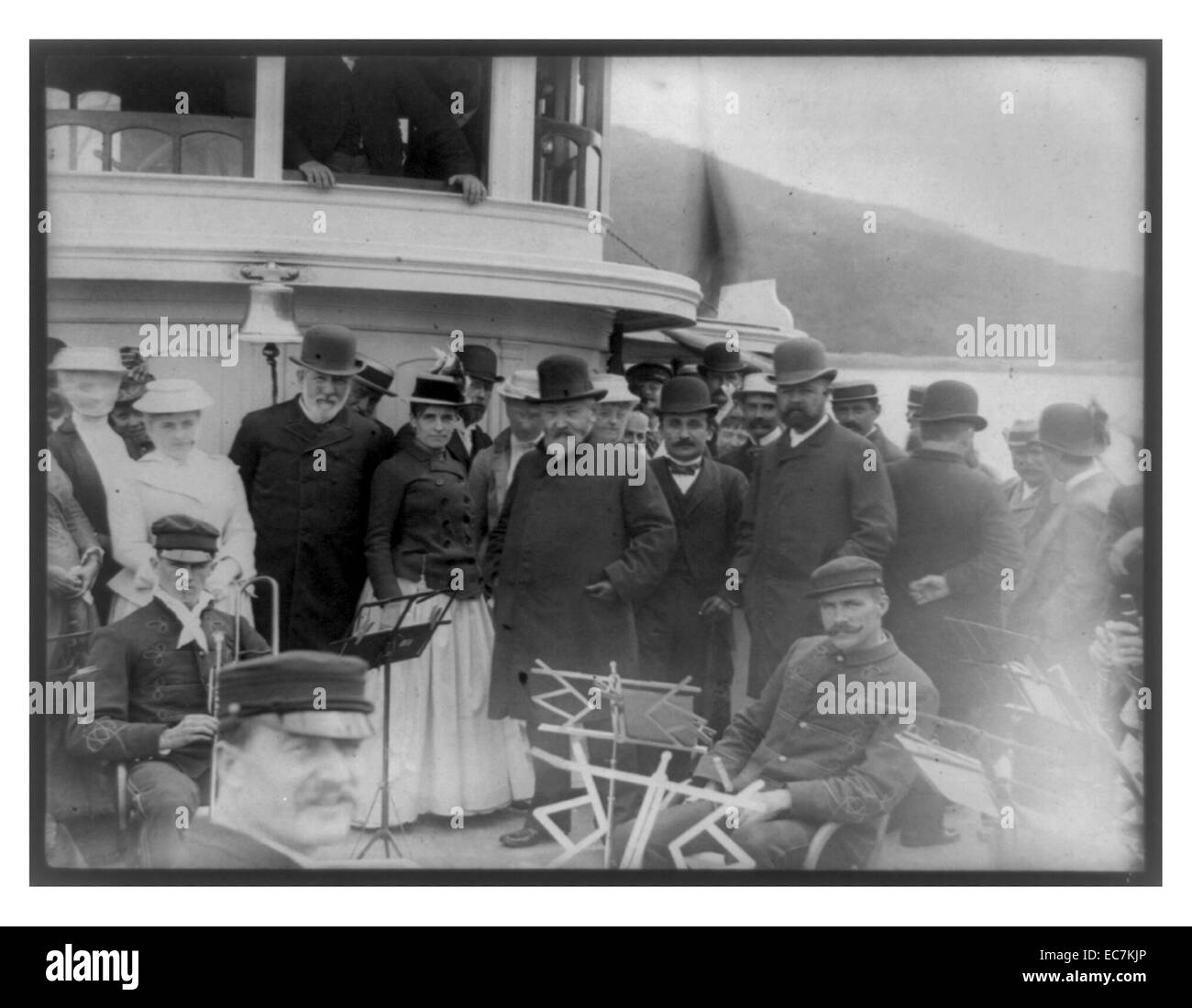 President Benjamin Harrison with James G. Blaine, Henry Cabot Lodge, and a group of other people including men of the Bar Harbour Band standing on the forward deck of the Frenchman's Bay Steamer Sappho. Stock Photo