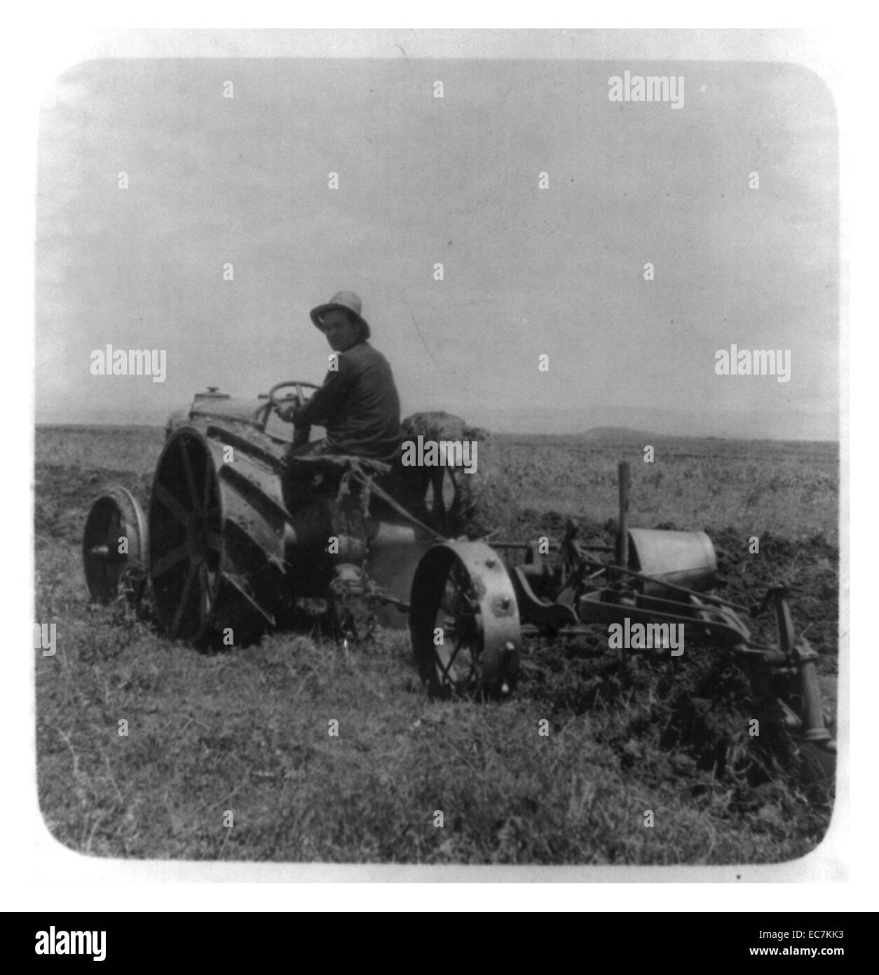 Jewish settler on a tractor ploughing in the Galilee of Palestine (now Israel). Stock Photo