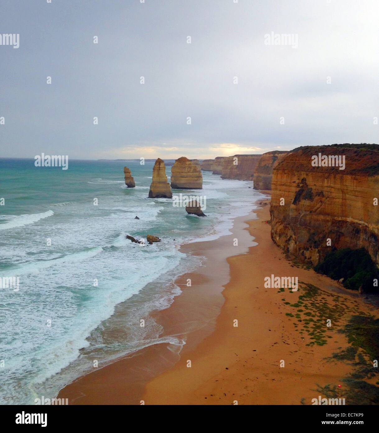 The Twelve Apostles is a collection of limestone stacks off the shore of the Port Campbell National Park, by the Great Ocean Road in Victoria, Australia. Their proximity to one another has made the site a popular tourist attraction. Stock Photo