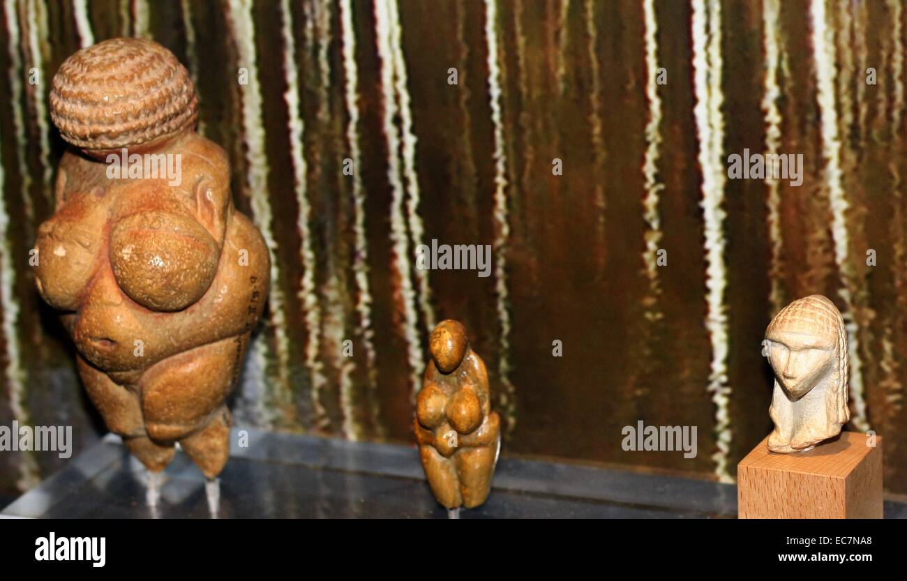 (Left) The Venus of Willendorf (replica), one of the early female figurines.  (Right) Venus of Brassempouy, a fragmentary ivory figurine, from the Upper Palaeolithic. discovered in a cave at Brassempouy, France in 1892. Small female figurines are found across Europe from France to Russia about 28,000-20,000 years ago. Stock Photo
