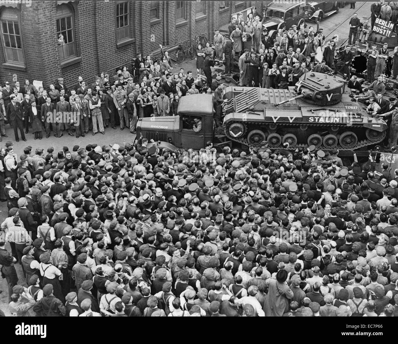 Crowds of people and a guard of honour of tanks, meeting M. Maisky, Soviet ambassador, and members of the Russian military mission when they arrived at a tank factory, where the week's tank production is for Russia, showing the 'Stalin' tank, which had just been christened by Madame Maisky Stock Photo