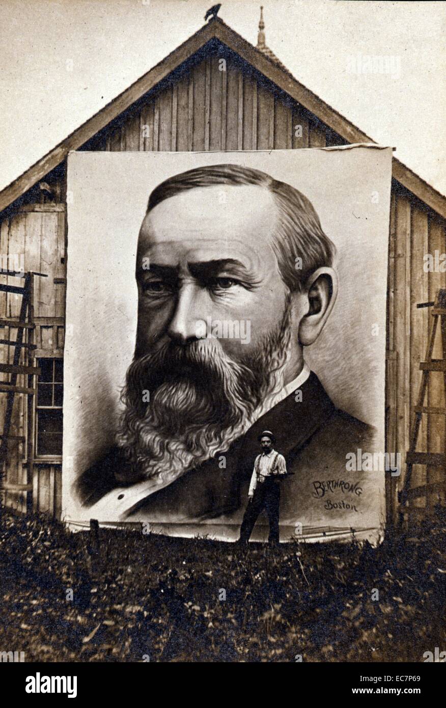 Giant painting of President Benjamin Harrison displayed on the side of a barn with the artist standing next to it. The artist signed the portrait 'Berthrong Boston.' Stock Photo