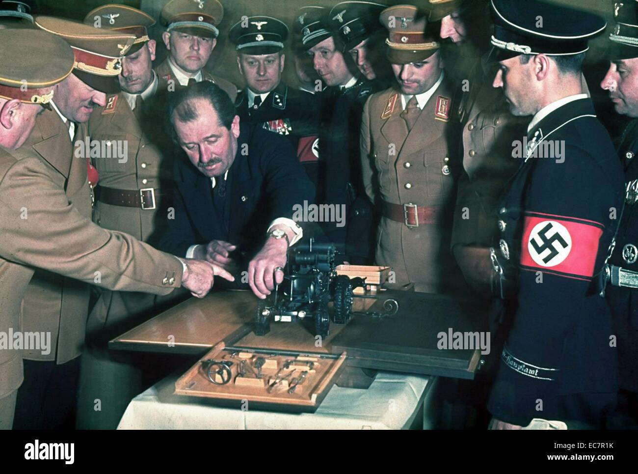 Colour photograph of the automobile engineer and designer Ferdinand Porsche (1875-1951) presents Adolf Hitler (1889-1945) with a model car during celebrations for Hitler's 50th birthday, Berin Photographed by Hugo Jaeger. Dated 1939 Stock Photo