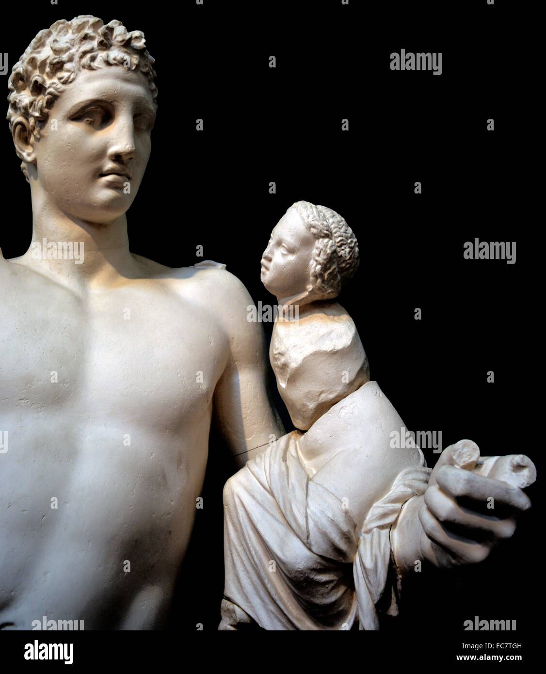 Hermes holding infant Dionysos. From Olympia, c340 BC. Hermes probably held grapes in his raised right hand, dangling them in front of the baby Dionysos. The statue was found in the temple of Hera, at Olympia, where Pausanias saw it in the 2nd century AD.  He said it is a work of Praxiteles, famous Athenian sculptor of the 4th century BC Stock Photo