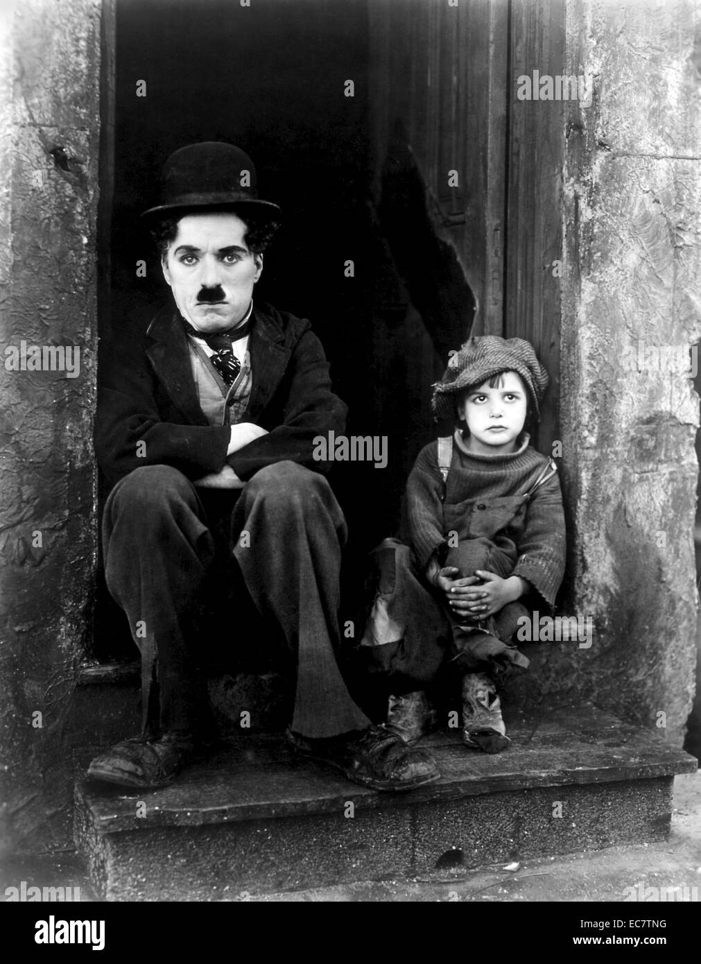 The Kid is a 1921 American silent comedy-drama film written, produced, directed by and starring Charlie Chaplin, and features Jackie Coogan as his adopted son and sidekick. This was Chaplin's first full-length film as a director. It was a huge success, and was the second-highest grossing film in 1921. Stock Photo