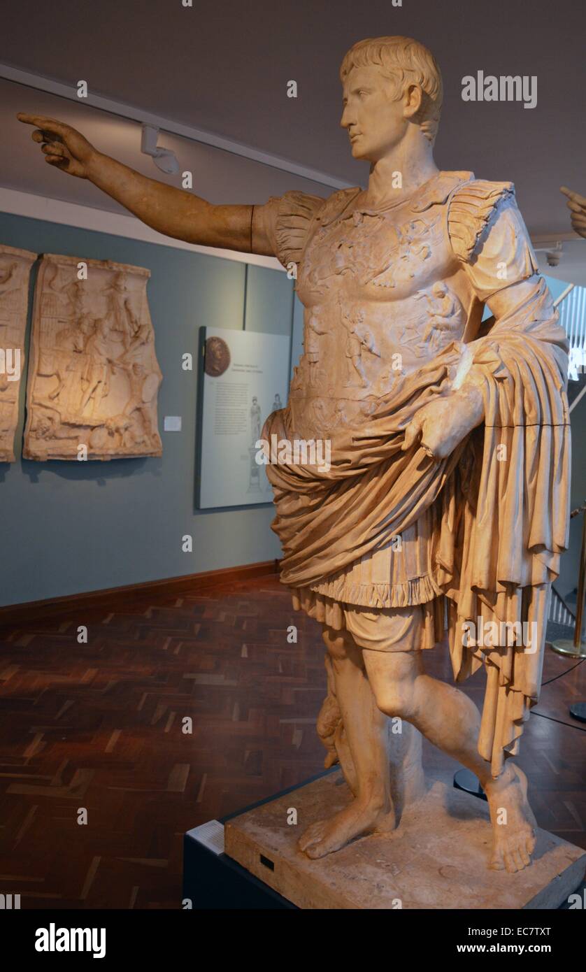 Emperor Augustus.  From Villa of Livia at Prima Porta, near Rome, c.20 BC.  Augustus rises his right arm in the gesture of a general addressing his troops.  The military commander's cloak and armour were the most distinctive of all Roman power costumes.  The breastplate carries an elaborate allegory of the return of the standards lost to the Parthians in 19 BC.  The marble statue was once brightly painted. Stock Photo