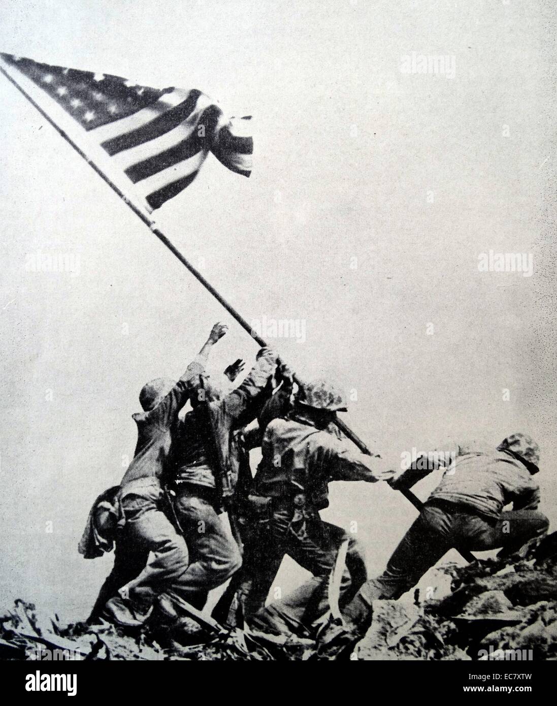 Raising the Flag on Iwo Jima is a historical photograph taken on February 23, 1945.  It depicts five US Marines and a US Navy corpsman raising a US flat atop Mount Suribachi, during the Battle of Iwo Jima in WW2. Stock Photo
