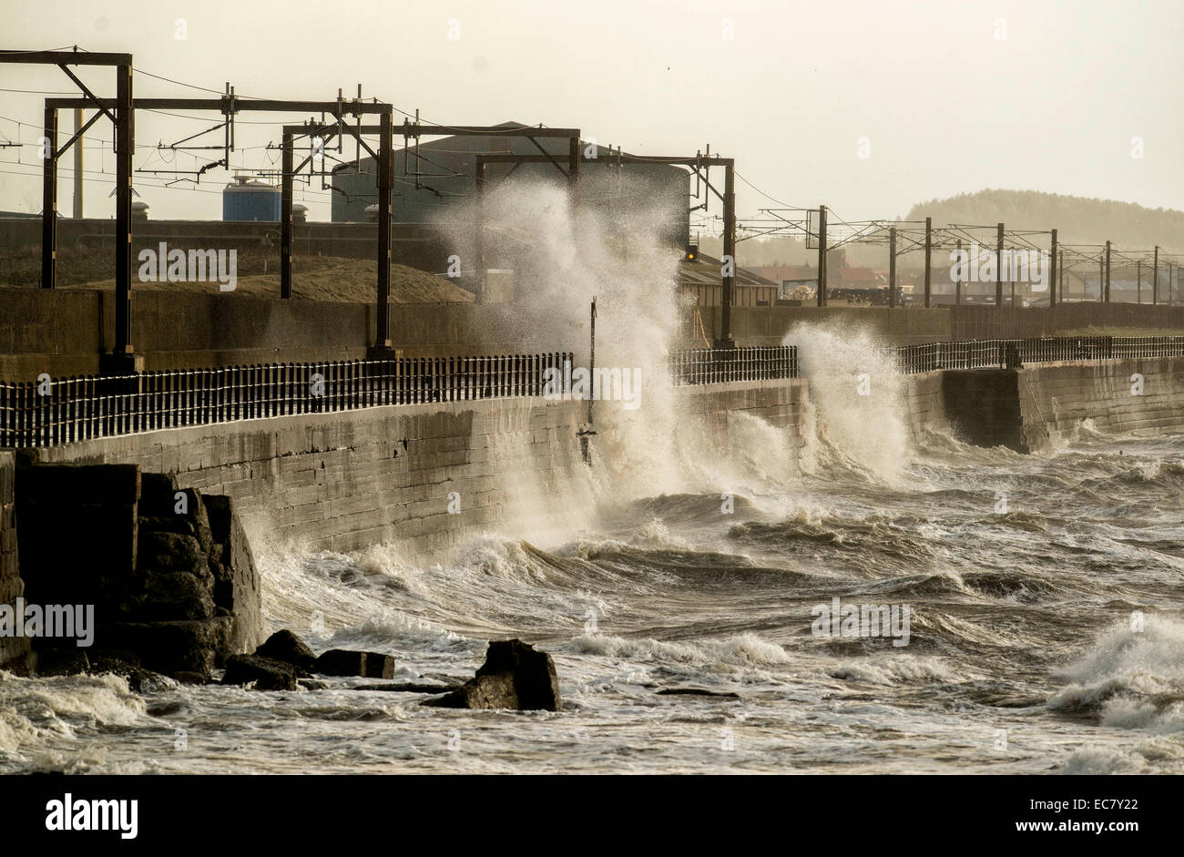 Waves as they crash over the promenade wall on December 10, 2014 in Saltcoats, Scotland. Stock Photo