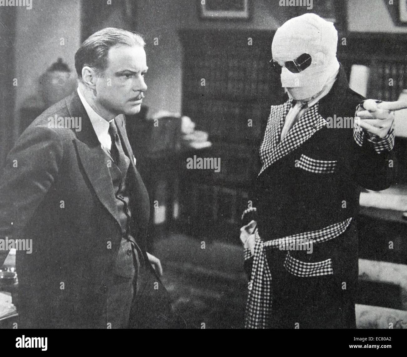 The Invisible Man, 1933.  Claude Rains orders the help of William Harrigan to do his will.  Rains made his picture debut in a film in which his face was never shown. Stock Photo