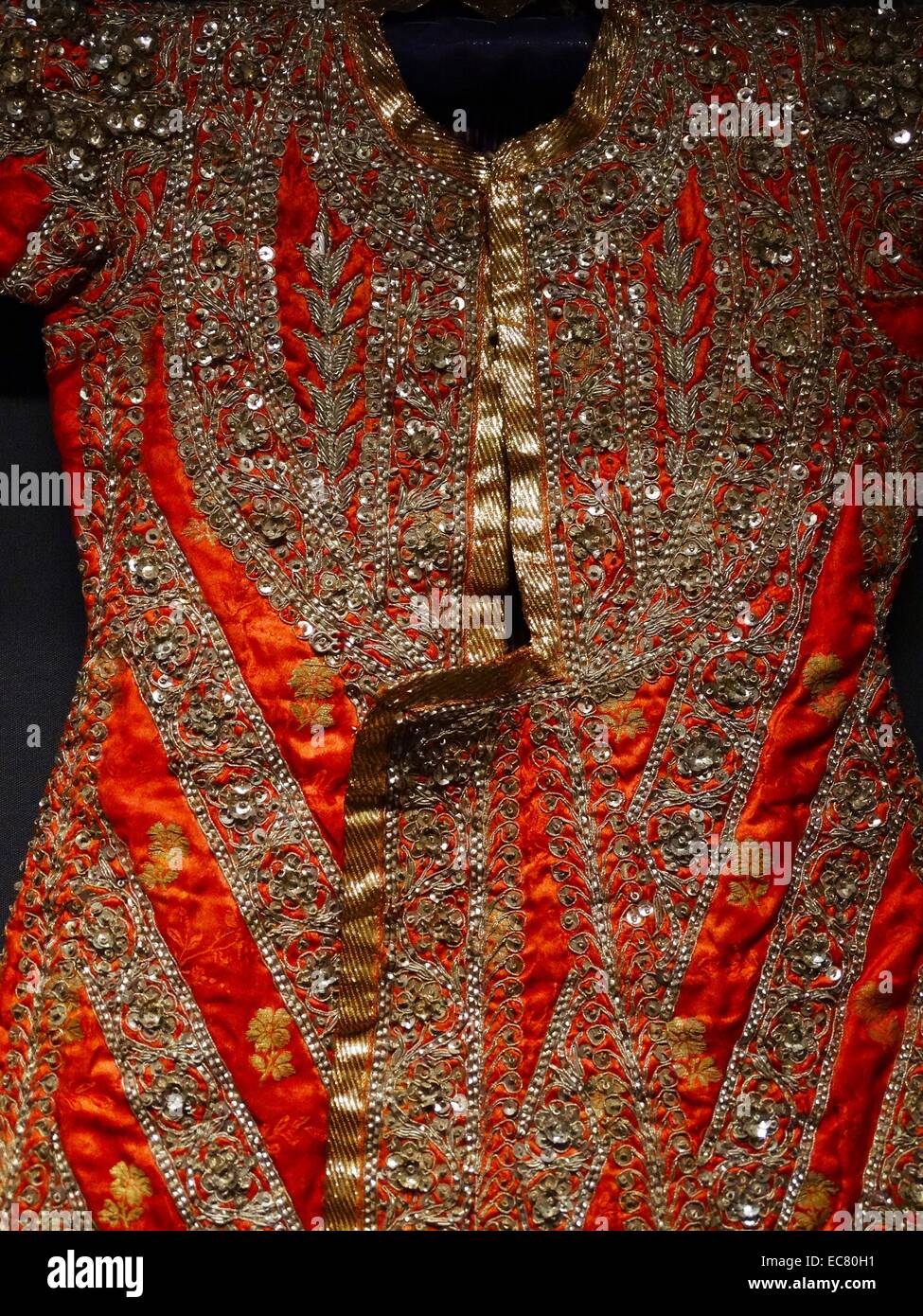 Boys coat in red silk embroidered with gilt thread and sequins; 1900 Stock Photo