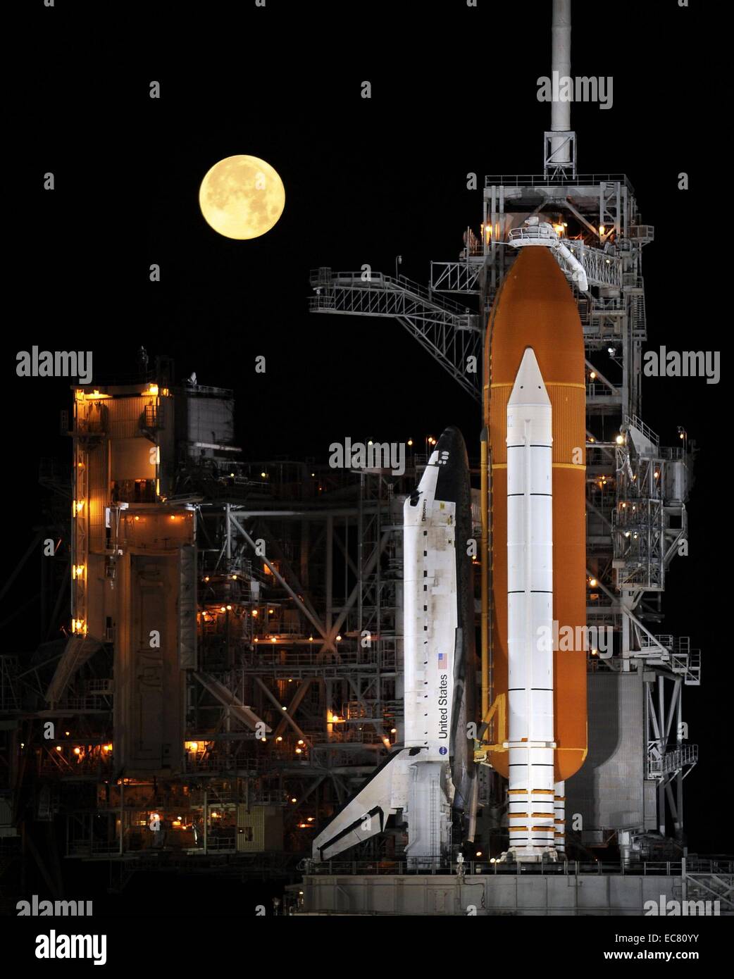 The Discovery space shuttle framed by a full moon. Its maiden flight was STS-41-D which launched on August 30, 1984. Over 27 years of service it flew 39 missions, gathering more flight time than any other spacecraft to date. Stock Photo