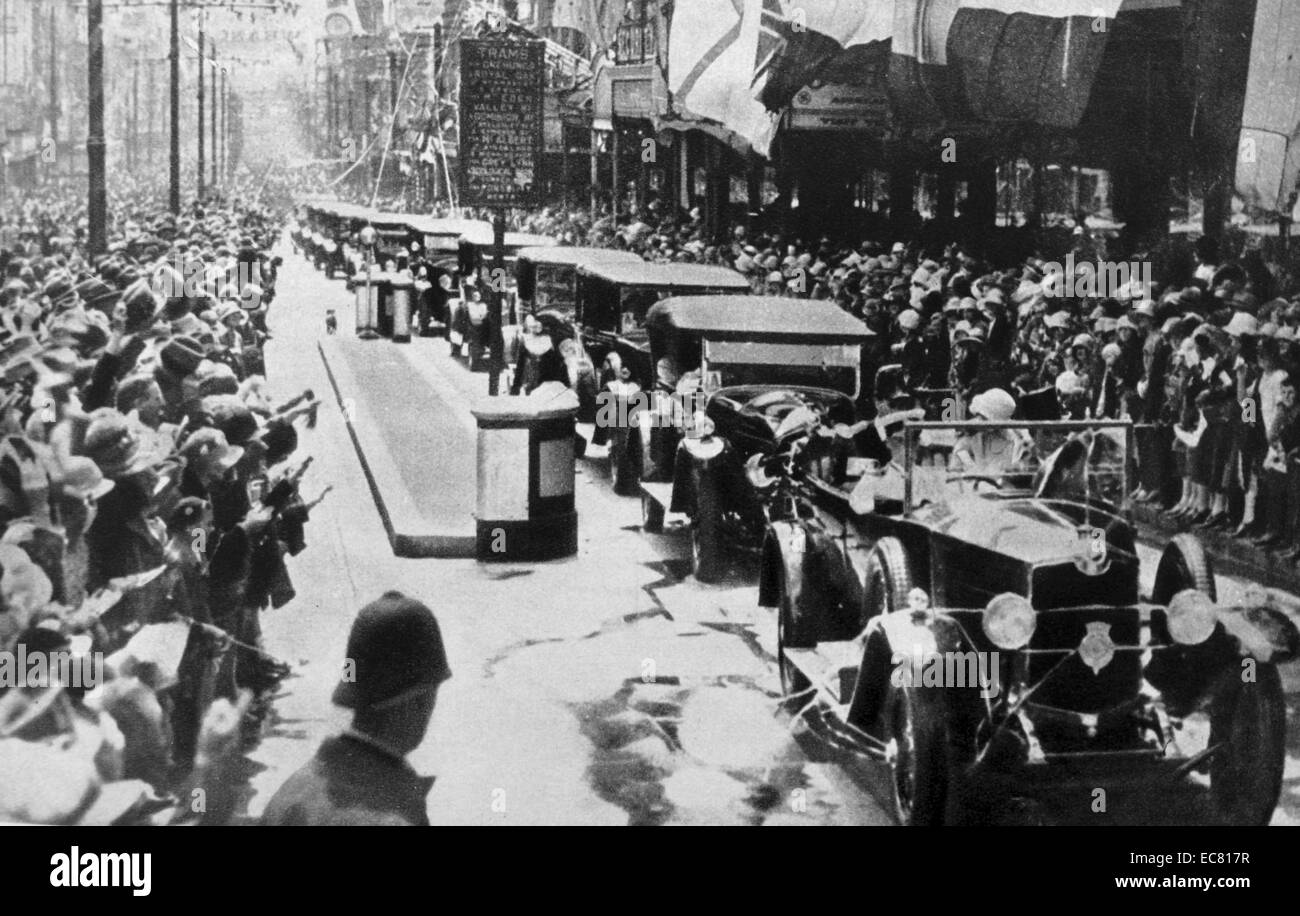 The picture shows the Duke and Duchess of York (later King George VI and Queen Elizabeth) arriving in New Zealand. They travel by vehicle as the crowds cheer. Stock Photo