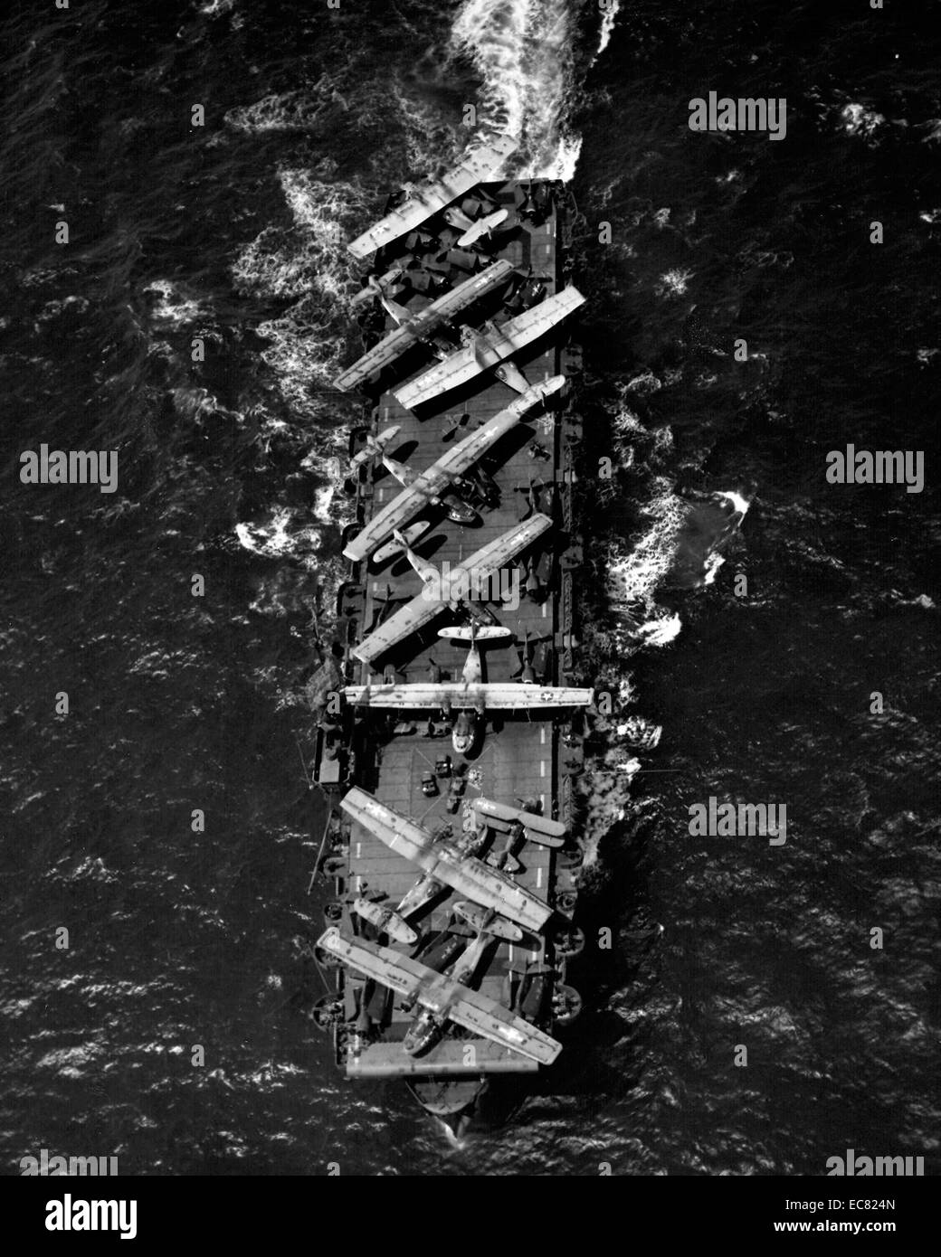 Image shows planes aboard the deck of the USS Thetis Bay. Transporting aircrafts in need of repair to Alameda, California. 1944 Stock Photo