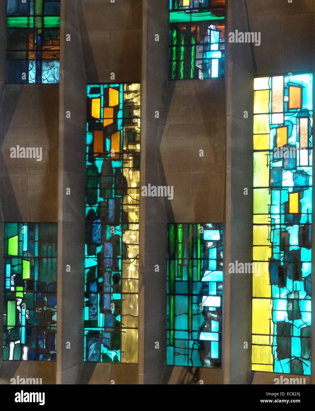 stained glass windows designed by john Piper depict the light of god, at the New St Michael's