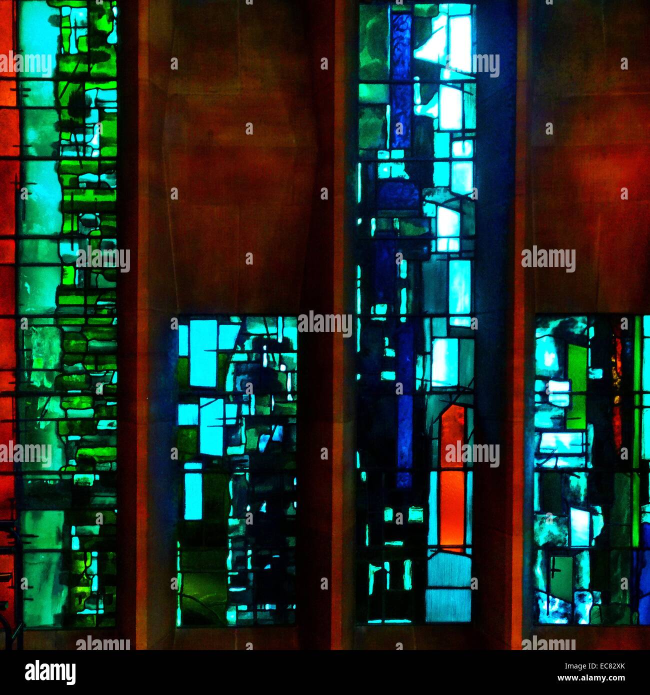 stained glass windows designed by john Piper depict the light of god, at the New St Michael's