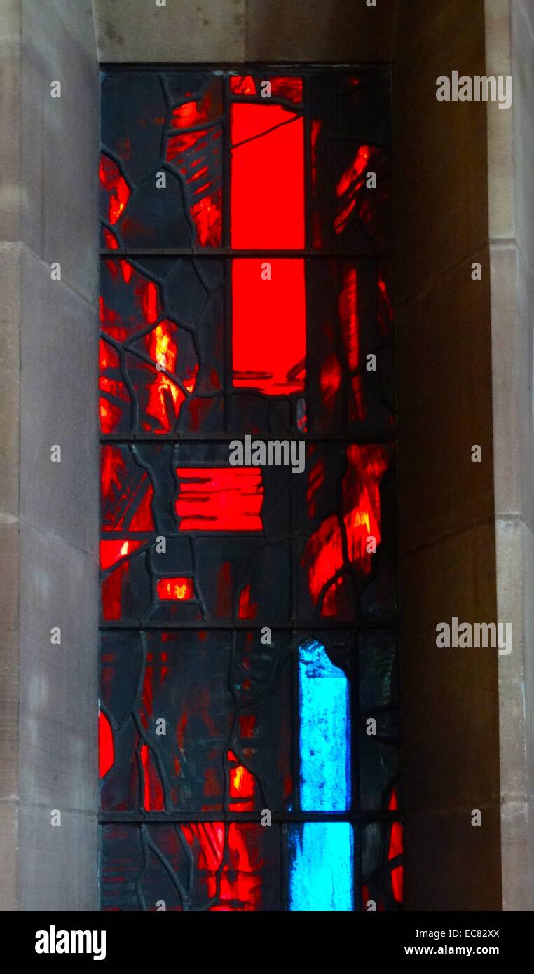 stained glass windows designed by john Piper depict the light of god, at the New St Michael's
