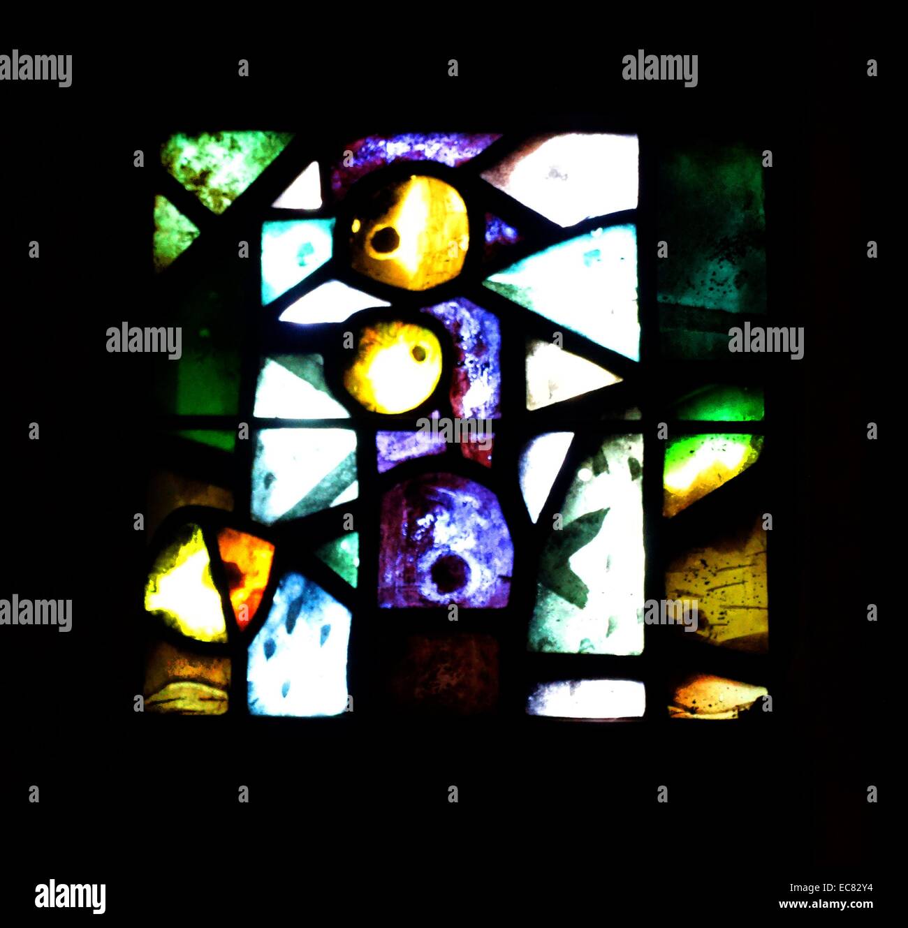 stained glass windows designed by john Piper depict the light of god