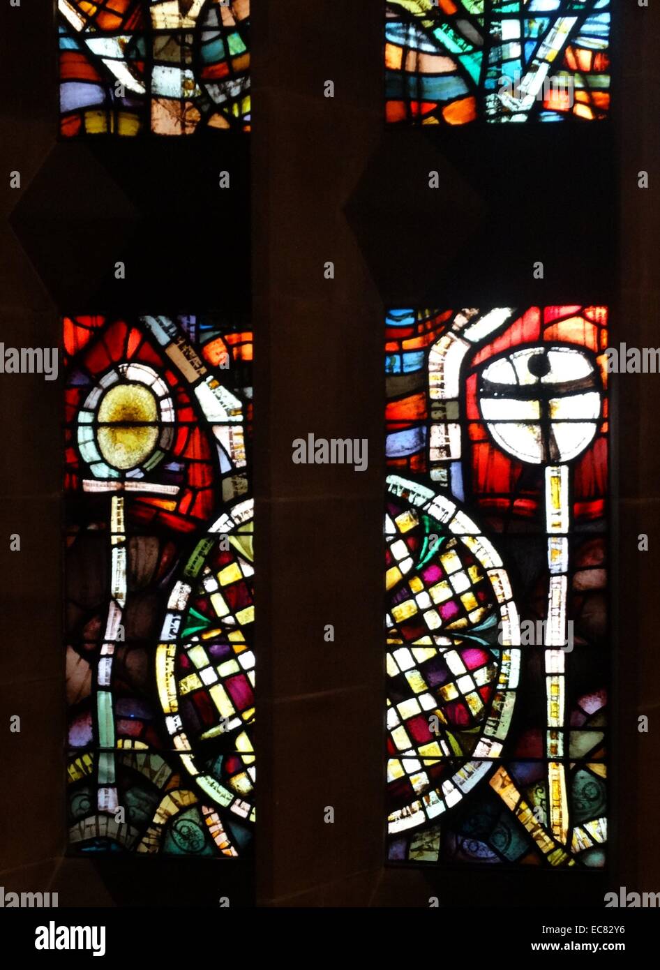 stained glass windows designed by john Piper depict the light of god, at the New St Michael's