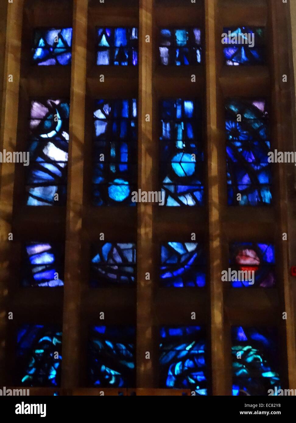 stained glass windows designed by john Piper depict the light of god