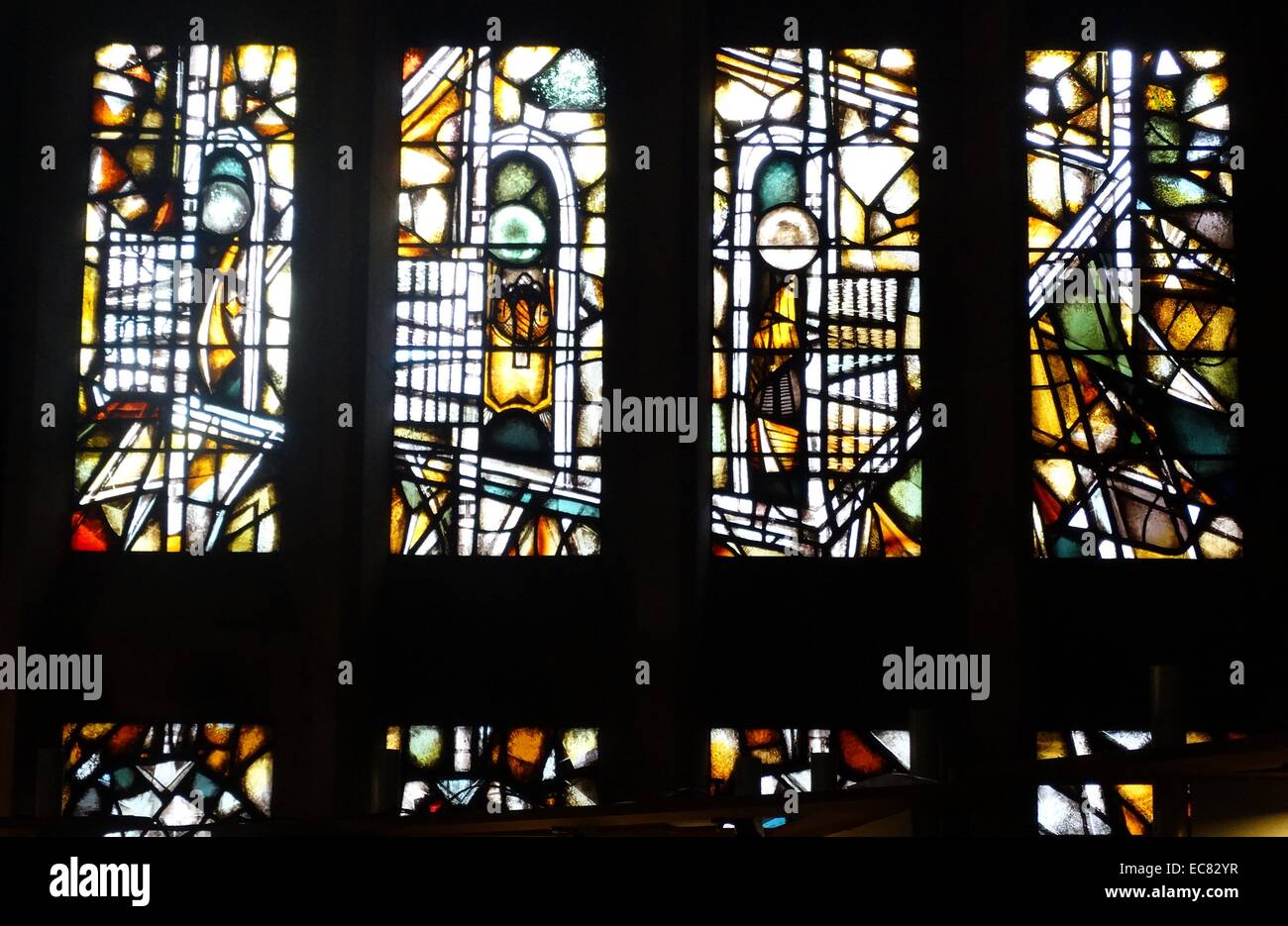 stained glass windows designed by john Piper depict the light of god, at the New St Michael's