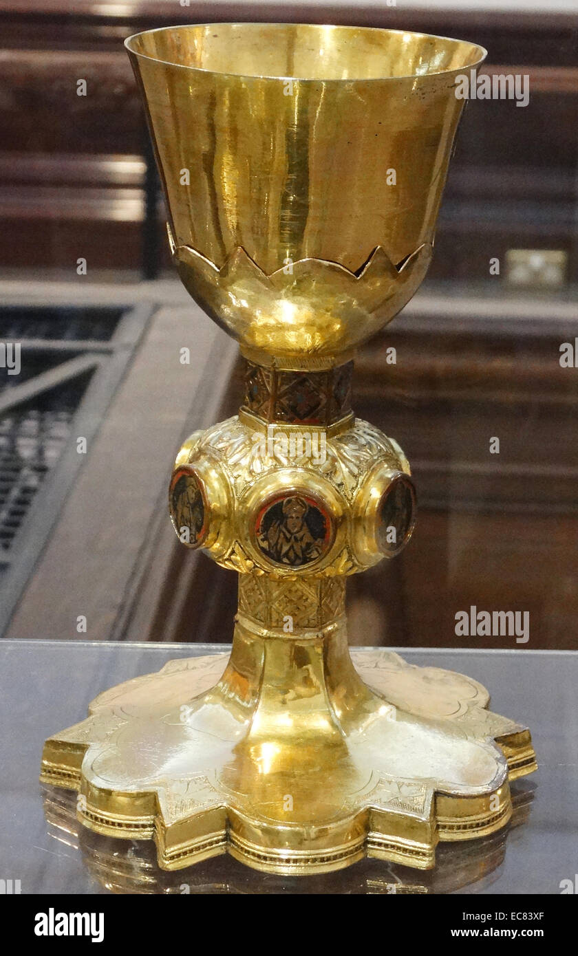 Chalice. Siena; Italy; 1325-75 made with copper and gold. A chalice is used during the Eucharist or Holy Communion; to hold wine. It is one of the most sacred vessels in Christian worship. This example is decorated with enamel medallions representing Christ on the cross and five saints. Stock Photo