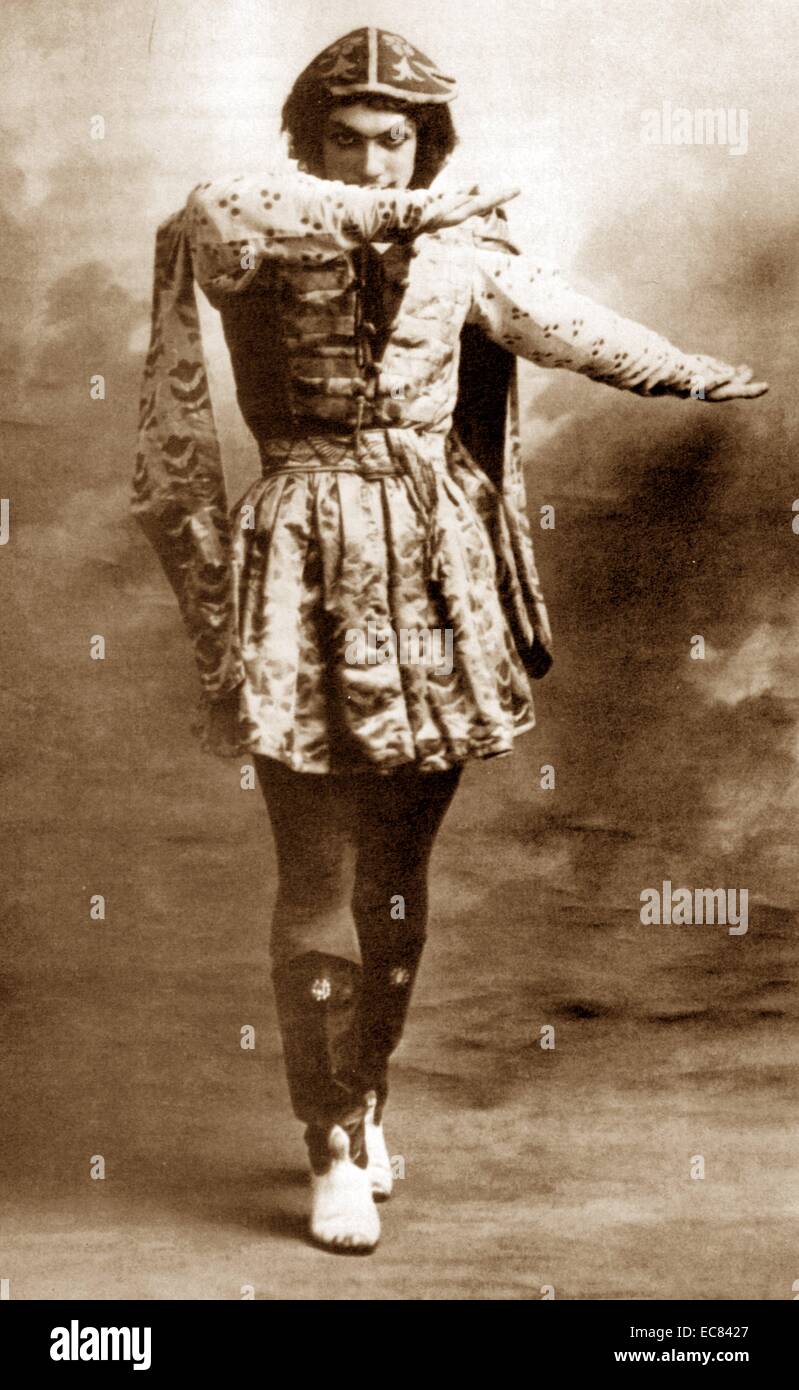 Vaslav Nijinsky (1889-1950) was a Russian ballet dancer who is often cited as the greatest male dancer of the early 20th century. Here he is wearing high boots and a long tunic, peering above his right arm, left arm extended to the side in the Grand pas classique hongrois from Le festin. Stock Photo