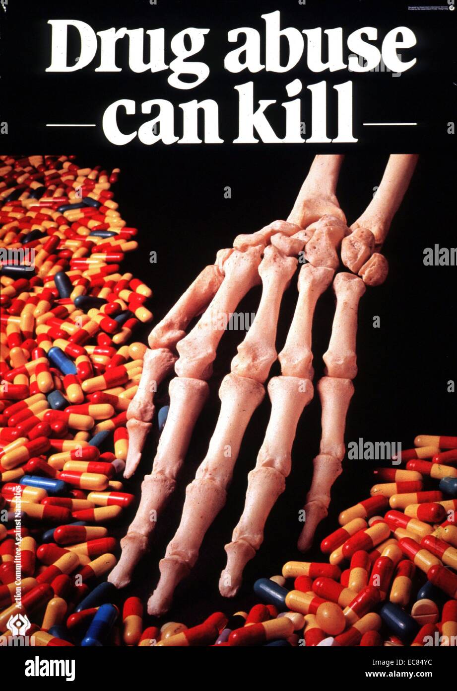 A Graphic poster shows a human skeleton hand, it's surrounded by a number of pills and capsules. The poster is designed to raise the awareness of drug abuse, warning people that it can be harmful and even cause death. c1950 Stock Photo