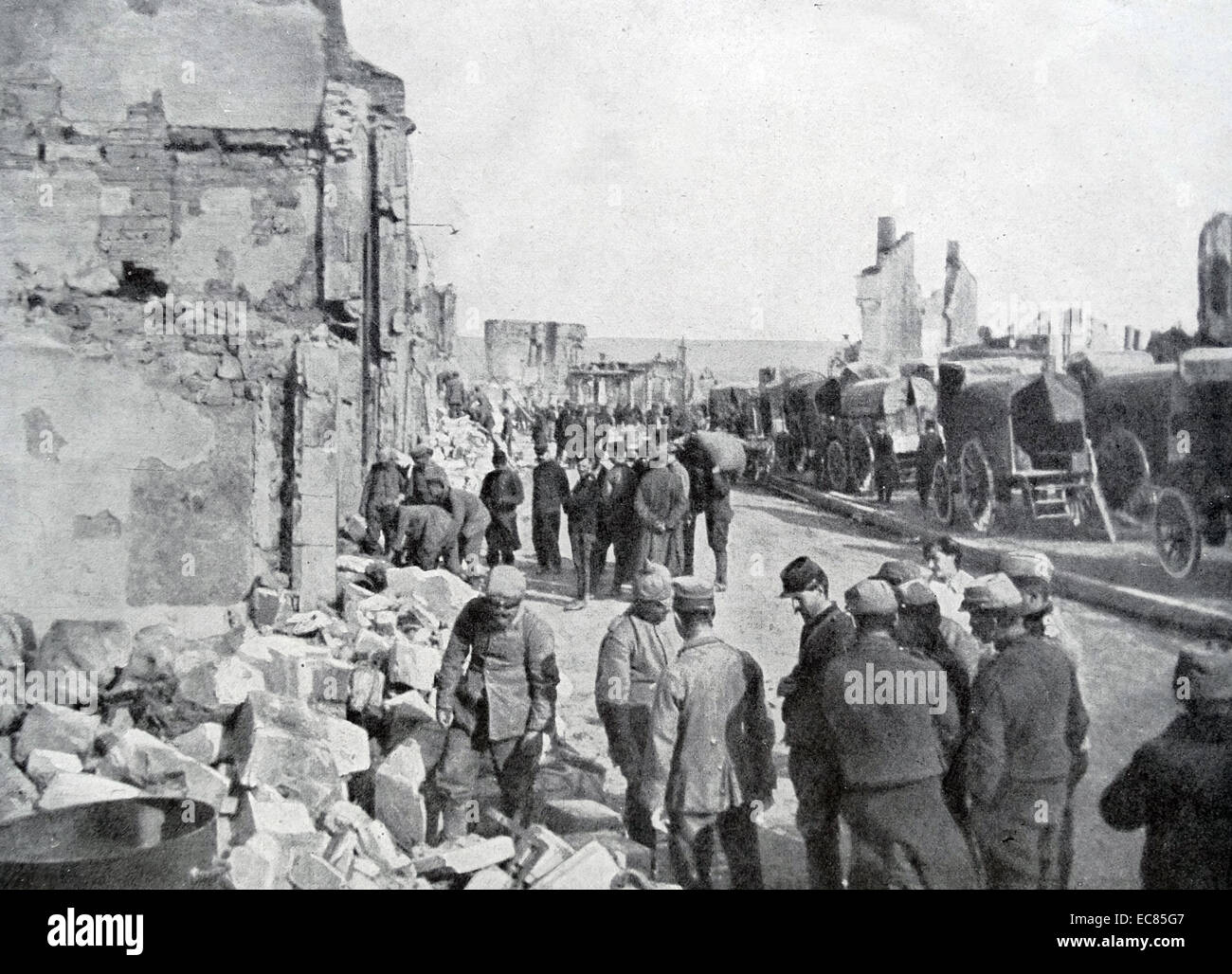 Photograph of German Prisoners of War helping to clear rubble at Clermont-en-Argonne, North-eastern France. Dated 1916 Stock Photo
