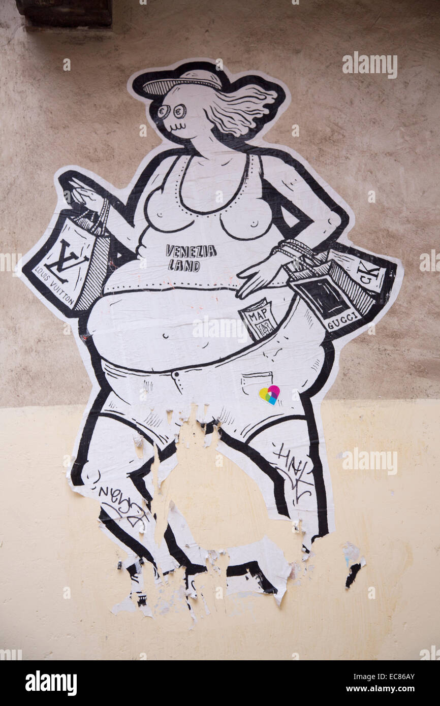 caricature on wall of female tourist in t-shirt and shorts with luxury shopping goods, Venice, Italy Stock Photo