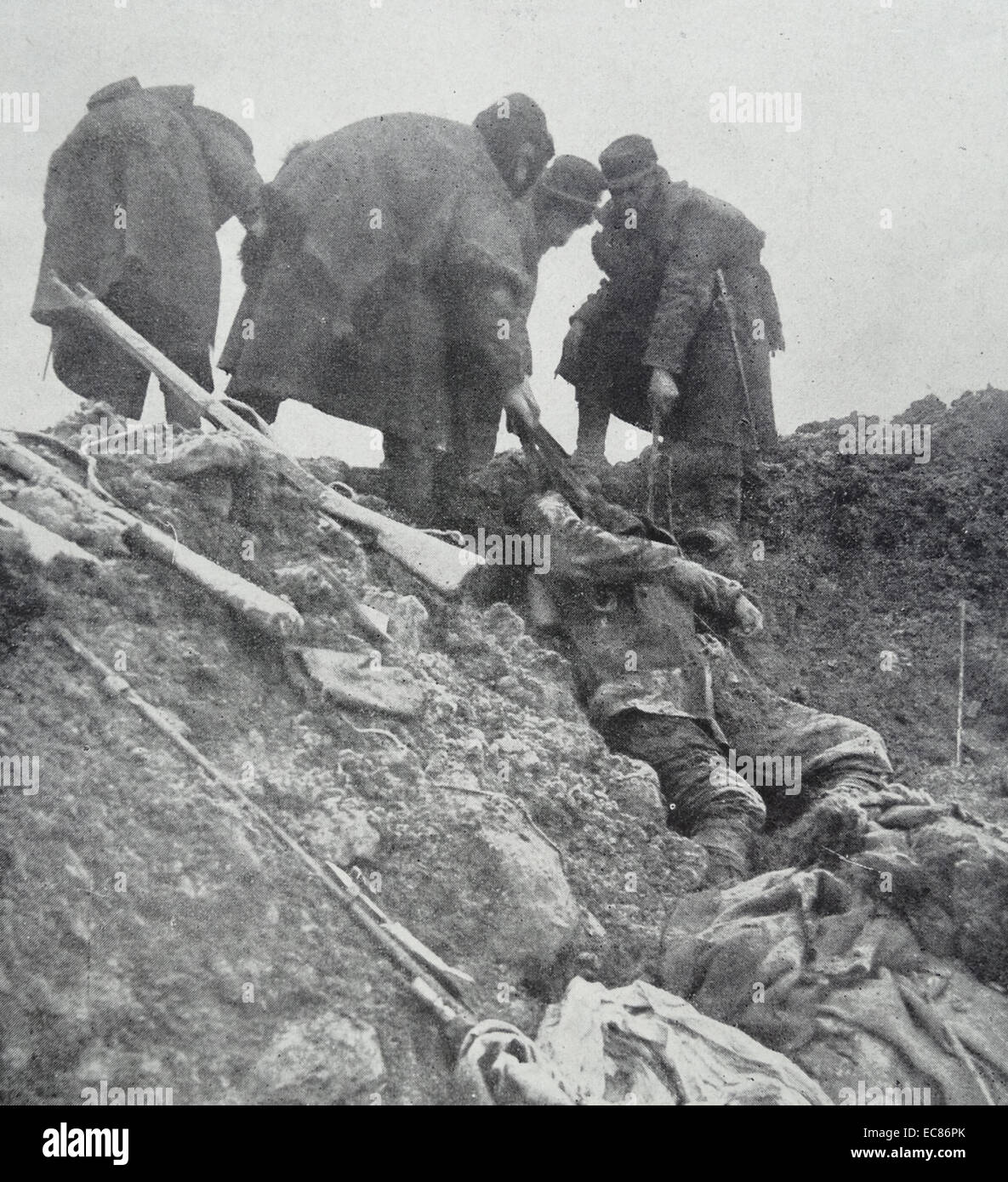 Photograph of French soldiers pulling out the body of a German from the ...