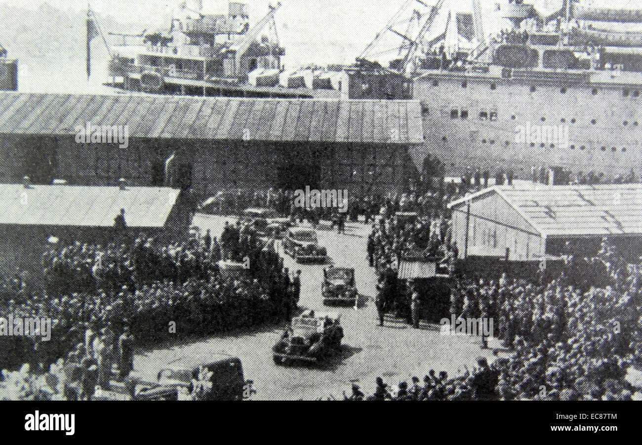 Photograph of Crown Prince Olaf driving past the crowded harbour in Oslo, filled with people to celebrate the liberation of Norway after World War Two. Dated 1945 Stock Photo