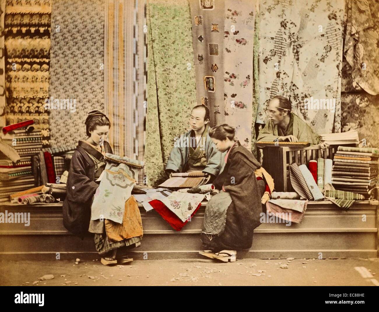 Colour Photograph of Japanese women shopping in a kimono shop. Dated 1890 Stock Photo