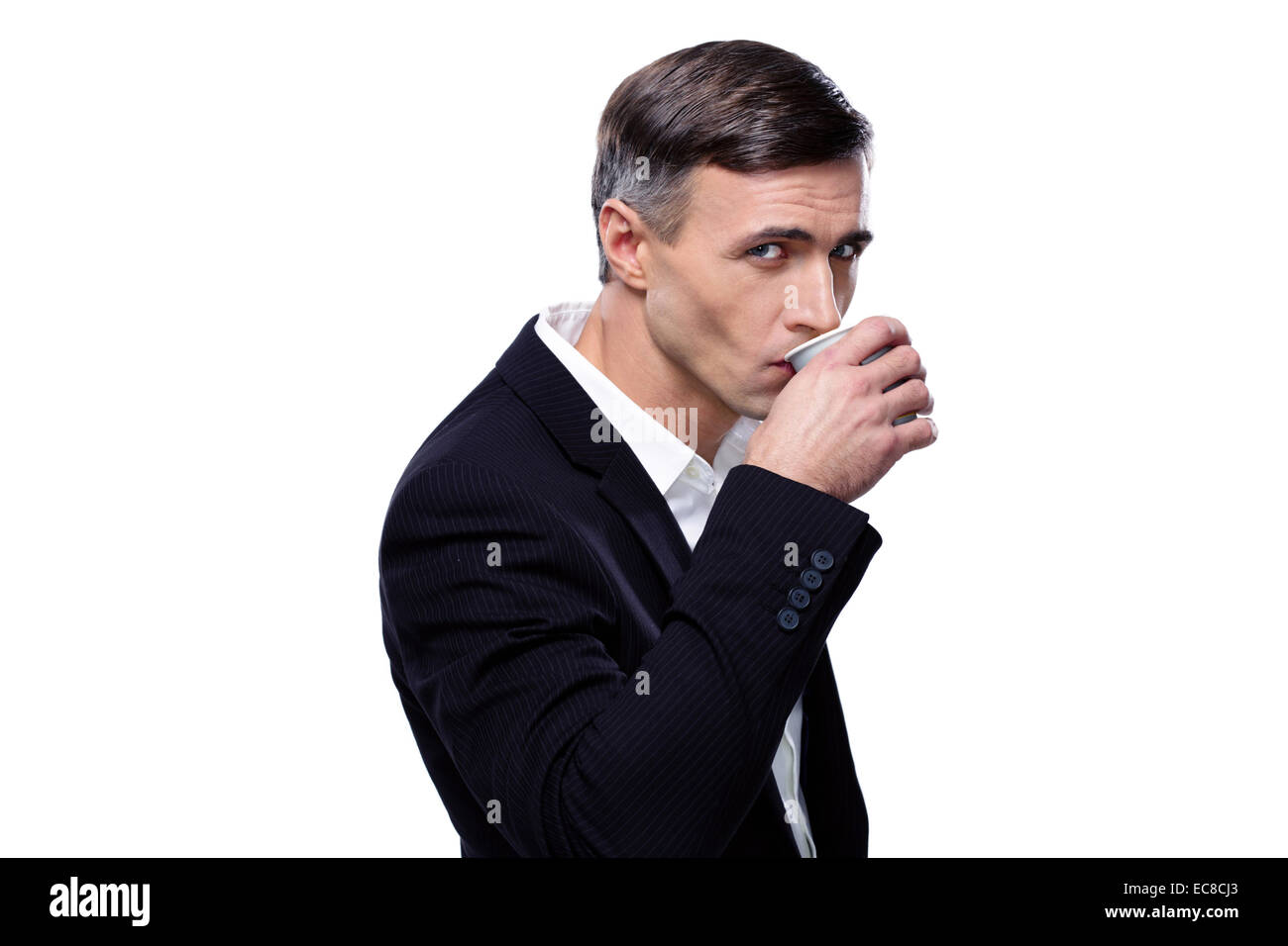 Confident businessman drinking coffee over white background Stock Photo