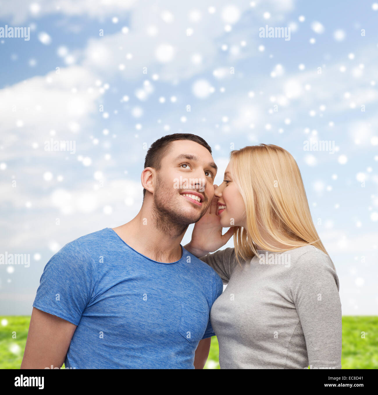 smiling girlfriend telling boyfriend secret Stock Photo
