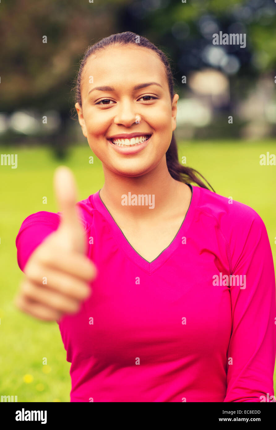 smiling african american woman showing thumbs up Stock Photo - Alamy
