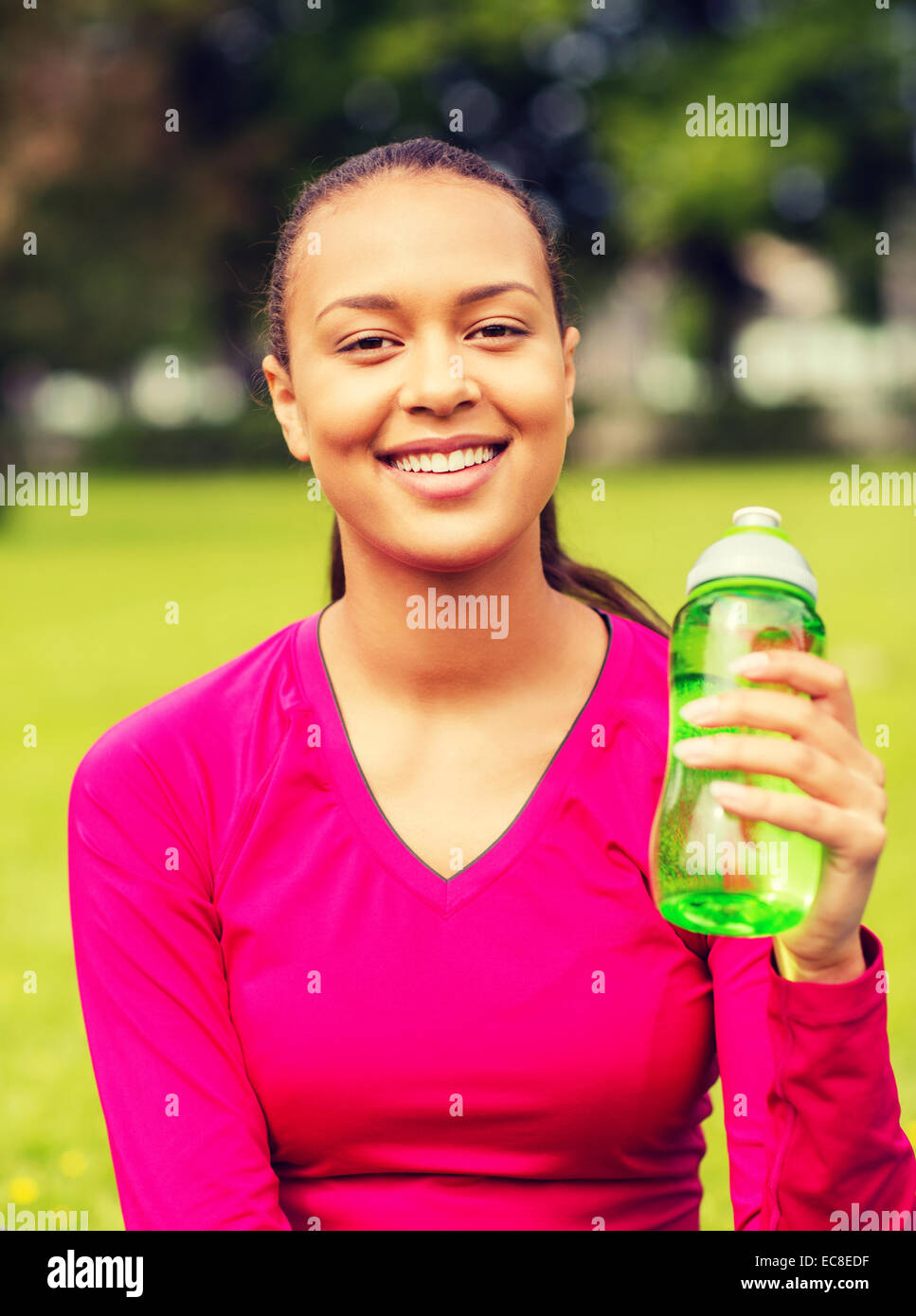 Teen girl in t-shirt standing and holding reusable water bottle in hands -  a Royalty Free Stock Photo from Photocase