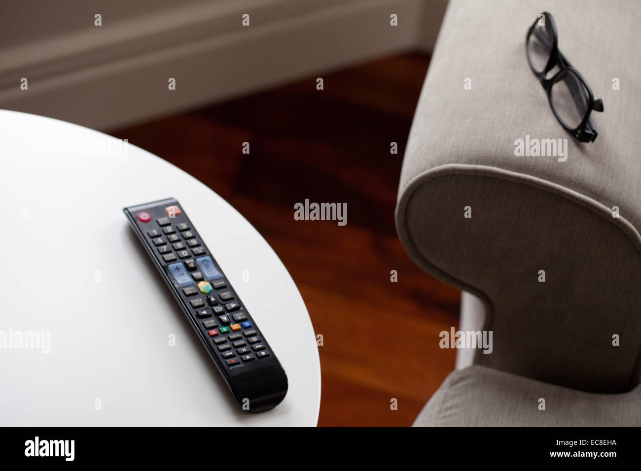 Remote control in living room near sofa Stock Photo