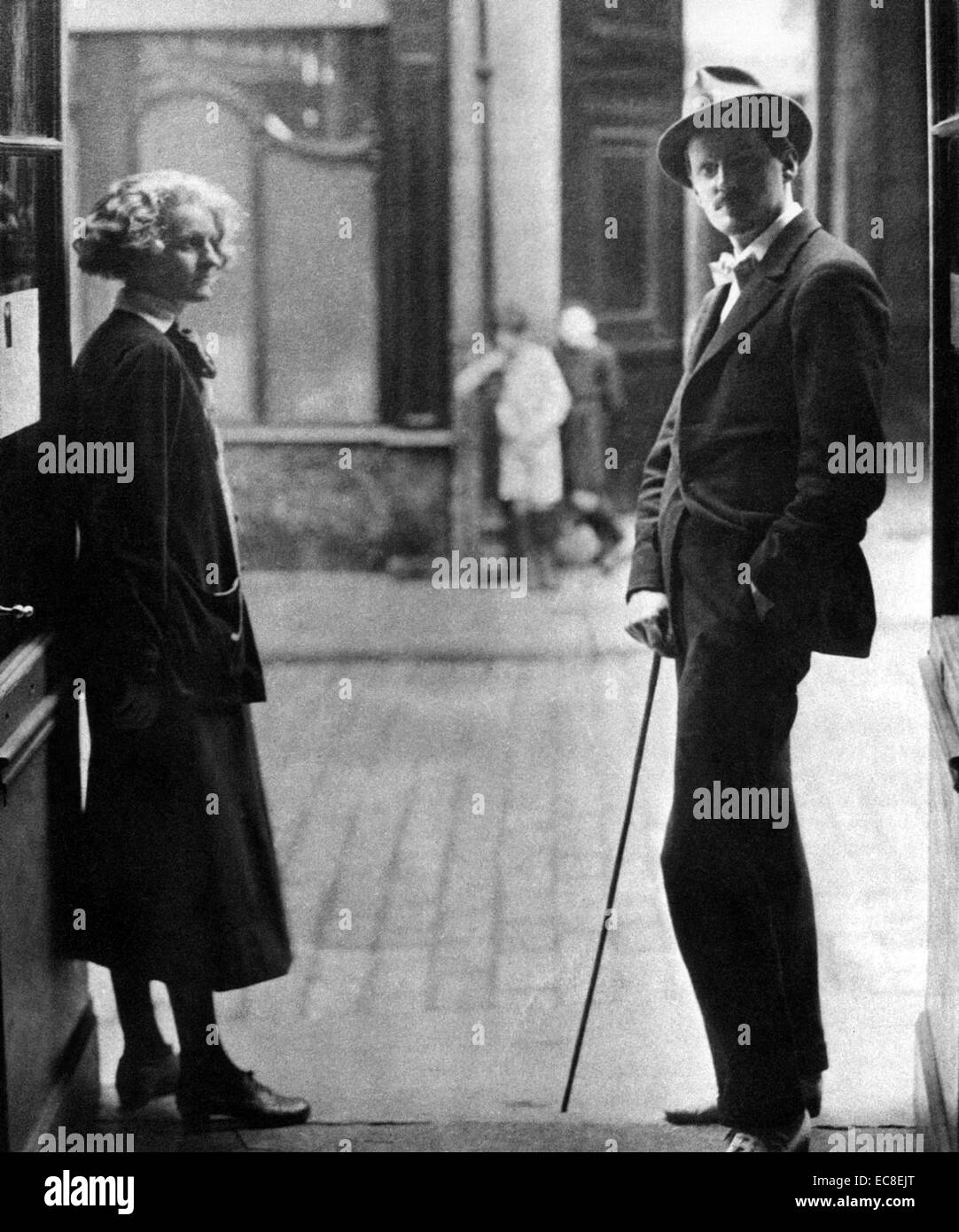 JAMES JOYCE (1882-1941) Irish author in 1920 with Silvia Beach who was the first to publish his novel Ulysses. They stand at the entrance to her Parisian bookshop Shakespeare & Co Stock Photo