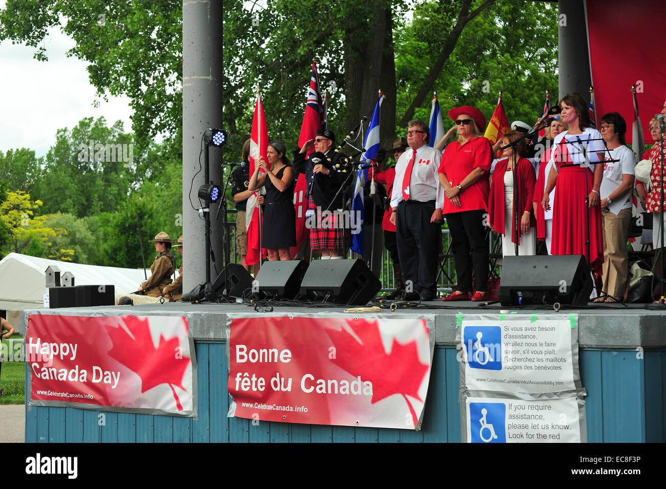 People stand for the Canadian National Anthem on a Canada Day event held in London, Ontario. Stock Photo