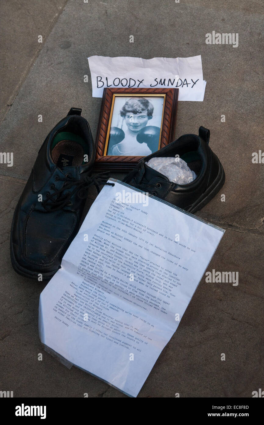 London, UK. 10th December, 2014. The shoes of hundreds of victims who died in Ireland, North and South during the Troubles are lined up opposite Downing Street as families demand that a proper investigation into over 3,600 deaths and 40,000 injuries on all sides, sets the truth free. PICTURED: The poignant memorial of John Francis "Jackie" Duddy who at 17 years old was killed on Bloody Sunday after going to join the march for a "bit of craic". Credit:  Paul Davey/Alamy Live News Stock Photo