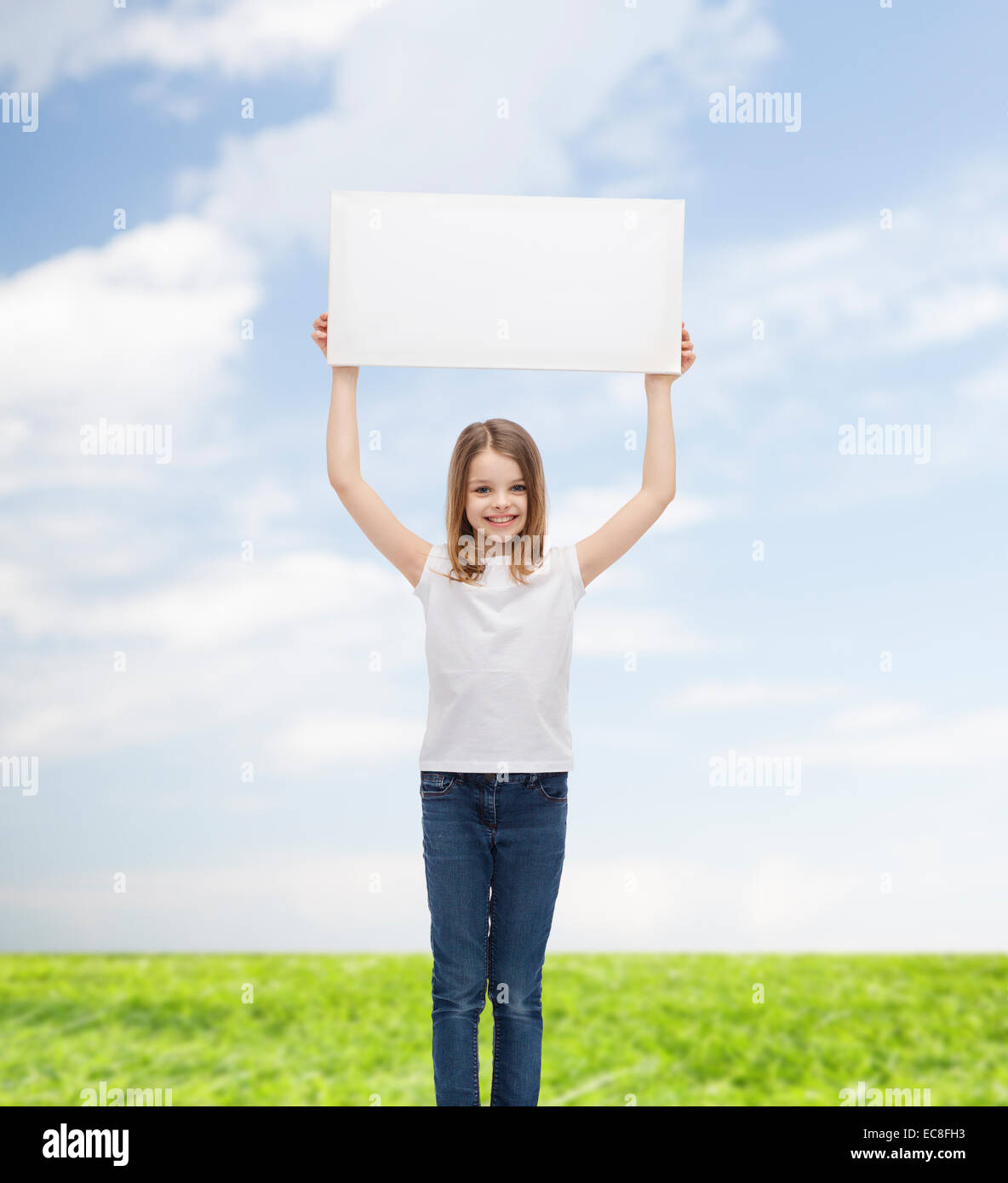 smiling little girl holding blank white board Stock Photo - Alamy