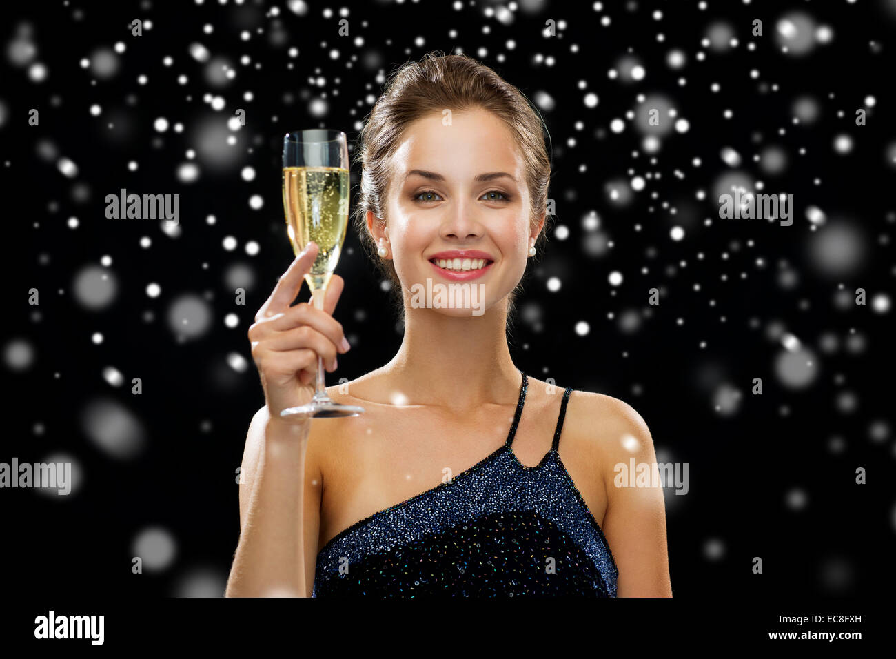 smiling woman holding glass of sparkling wine Stock Photo Alamy