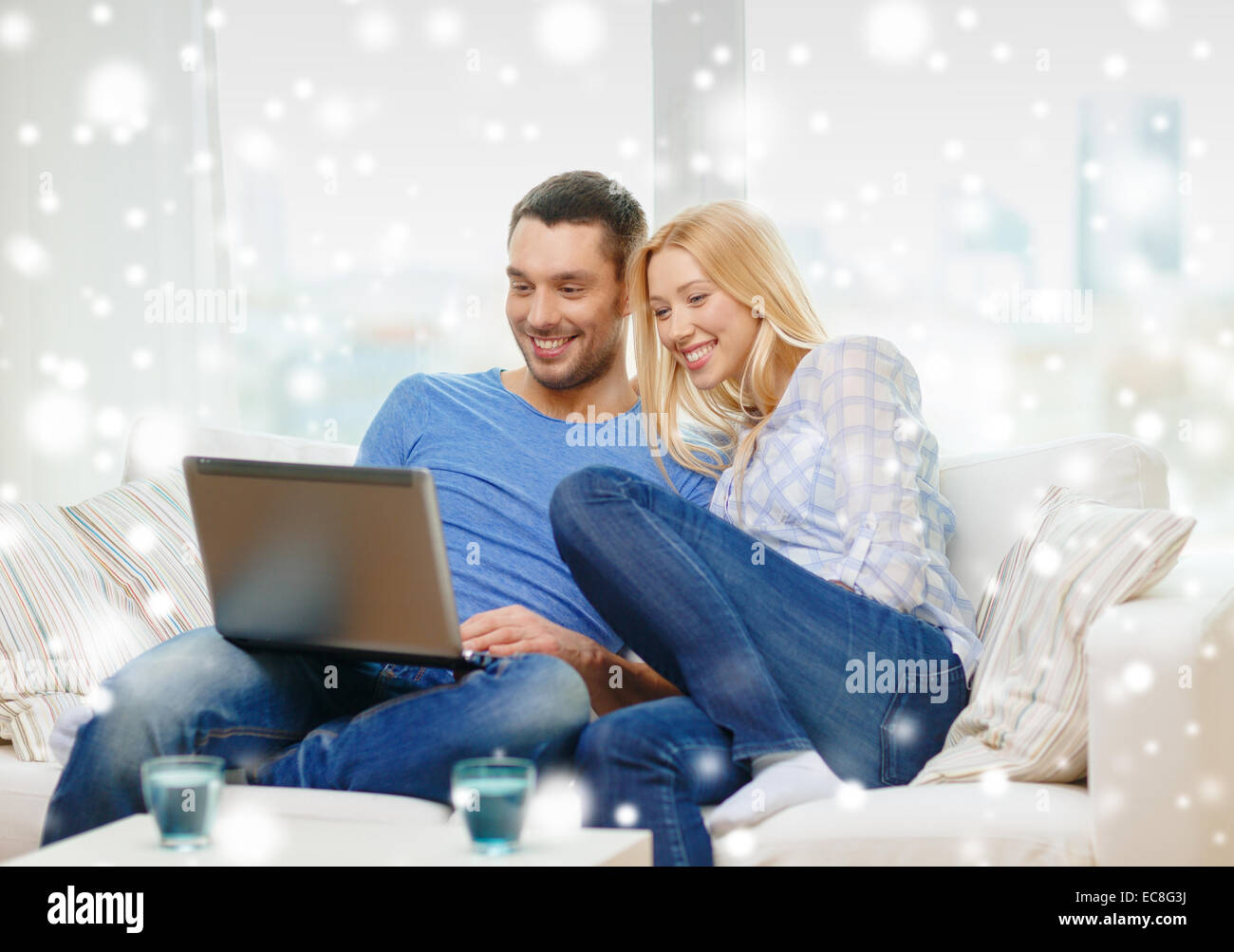 smiling happy couple with laptop at home Stock Photo - Alamy