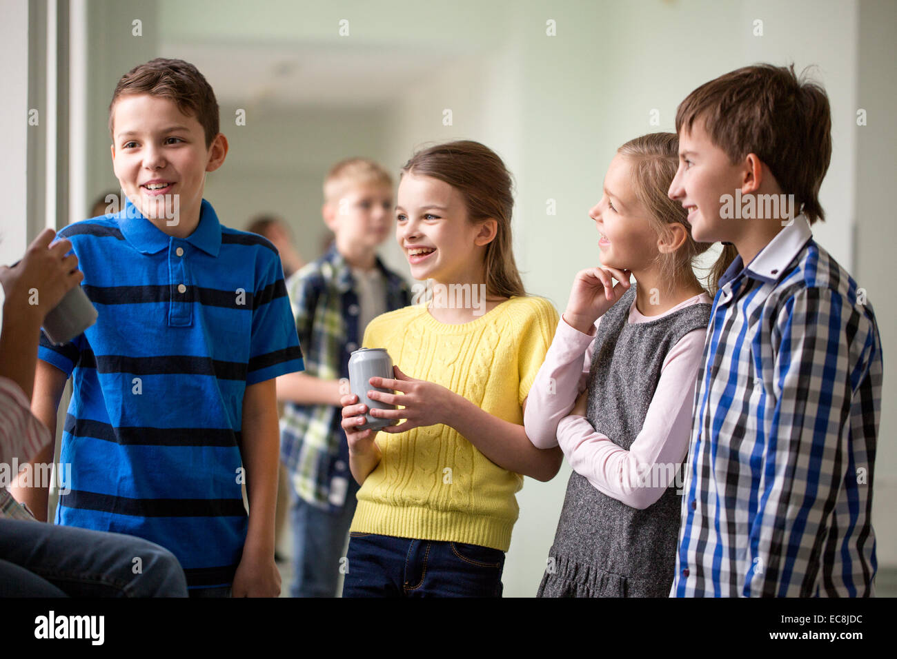 group of school kids with soda cans in corridor Stock Photo