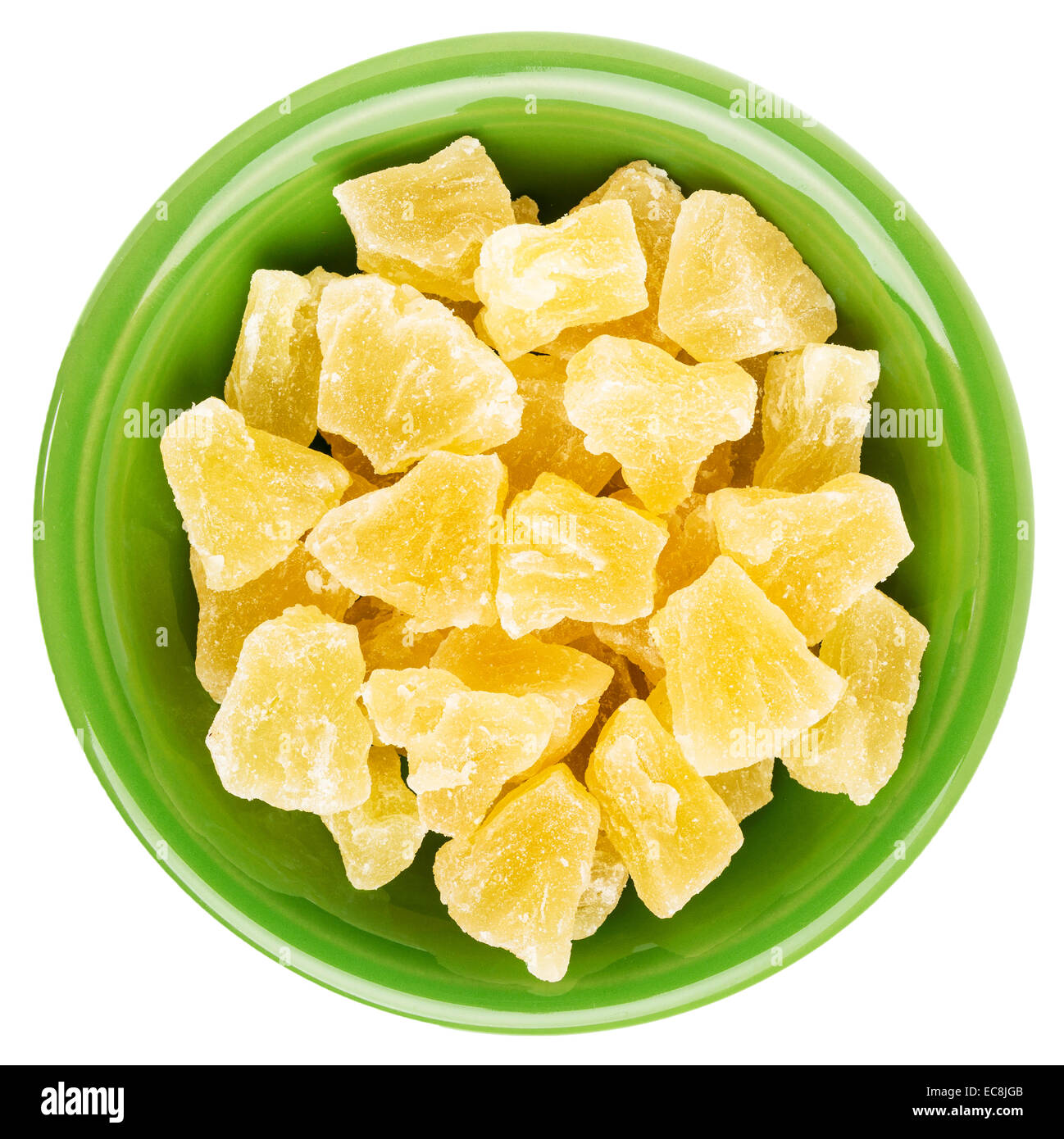 chunks of dried pineapple in an isolated green ceramic bowl Stock Photo