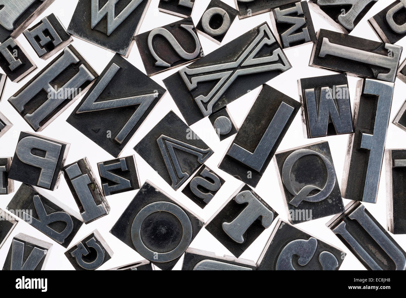 random letters in vintage letterpress metal type against white background Stock Photo Alamy