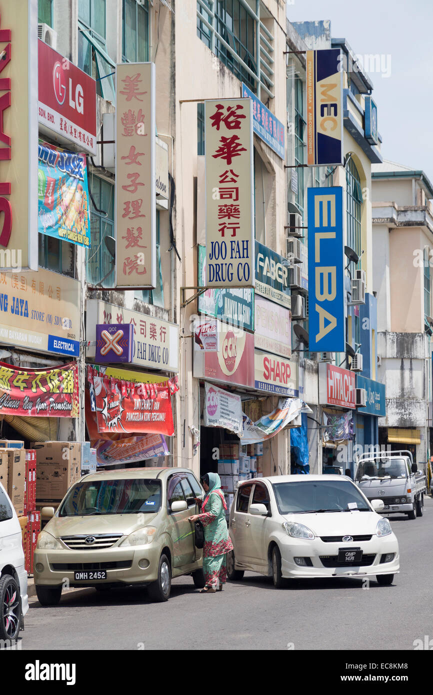 Street with shops and cars, Miri, Malaysia Stock Photo